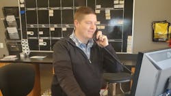 Keenan Walters talks to a customer on the phone.