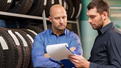 A shop owner discusses a repair job with a service advisor. A shop owner discusses a repair job with a service advisor.