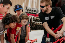 Teens work on a vehicle at Camp DRIVE, hosted by Black Hills Tire in South Dakota.