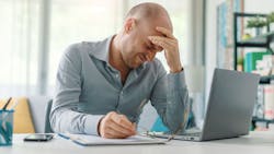 Man dealing with work-related stress. Man dealing with work-related stress.