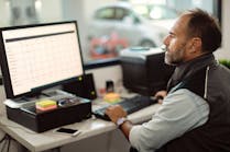 An auto repair shop owner looks at this computer. Understanding your shop&apos;s numbers can help you know what&apos;s best for your business and your customers.
