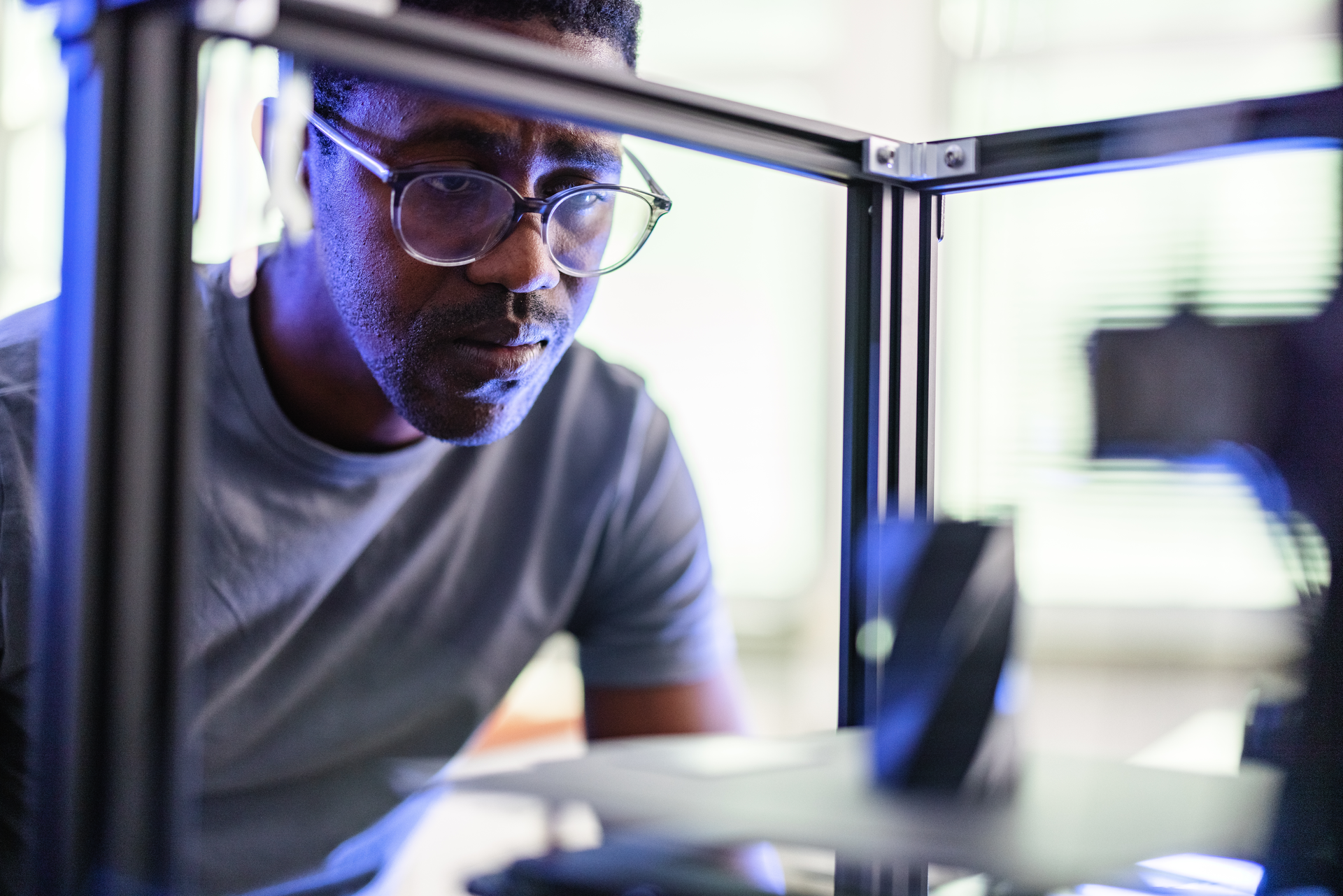 An engineer works on a project in a 3D printer. 3D printing technology can allow for unique auto parts to e reproduced.