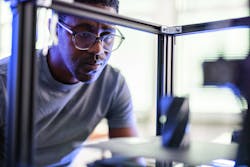 An engineer works on a project in a 3D printer. 3D printing technology can allow for unique auto parts to e reproduced. An engineer works on a project in a 3D printer. 3D printing technology can allow for unique auto parts to e reproduced.
