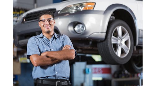 An auto technician stands in a shop. According to the 2023 Ratchet+Wrench Industry Survey Report, more technicians are becoming shop owners in 2023.
