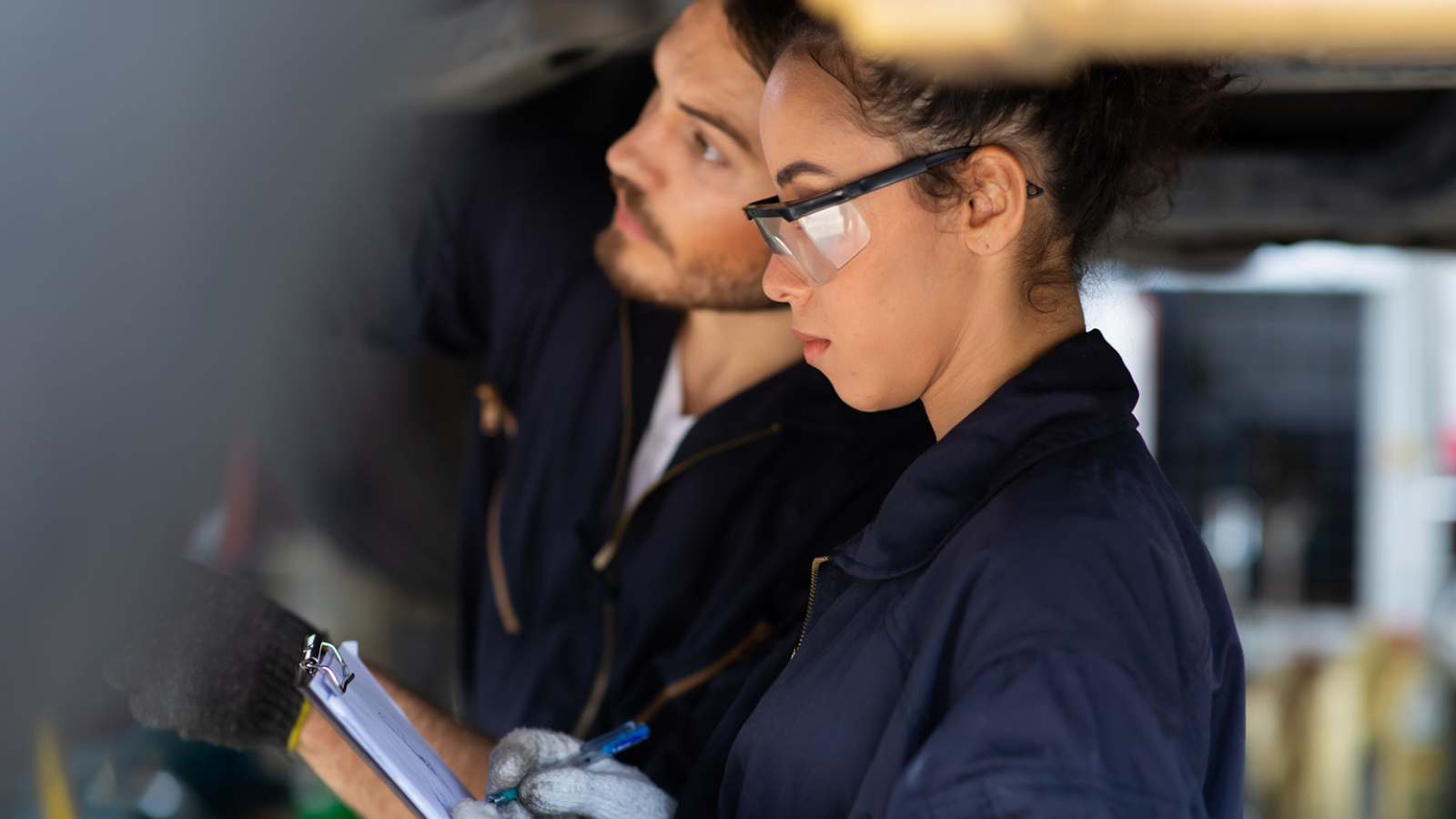 An automotive tech student learns on the job.