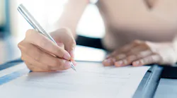 A woman fills out a customer satisfaction form.