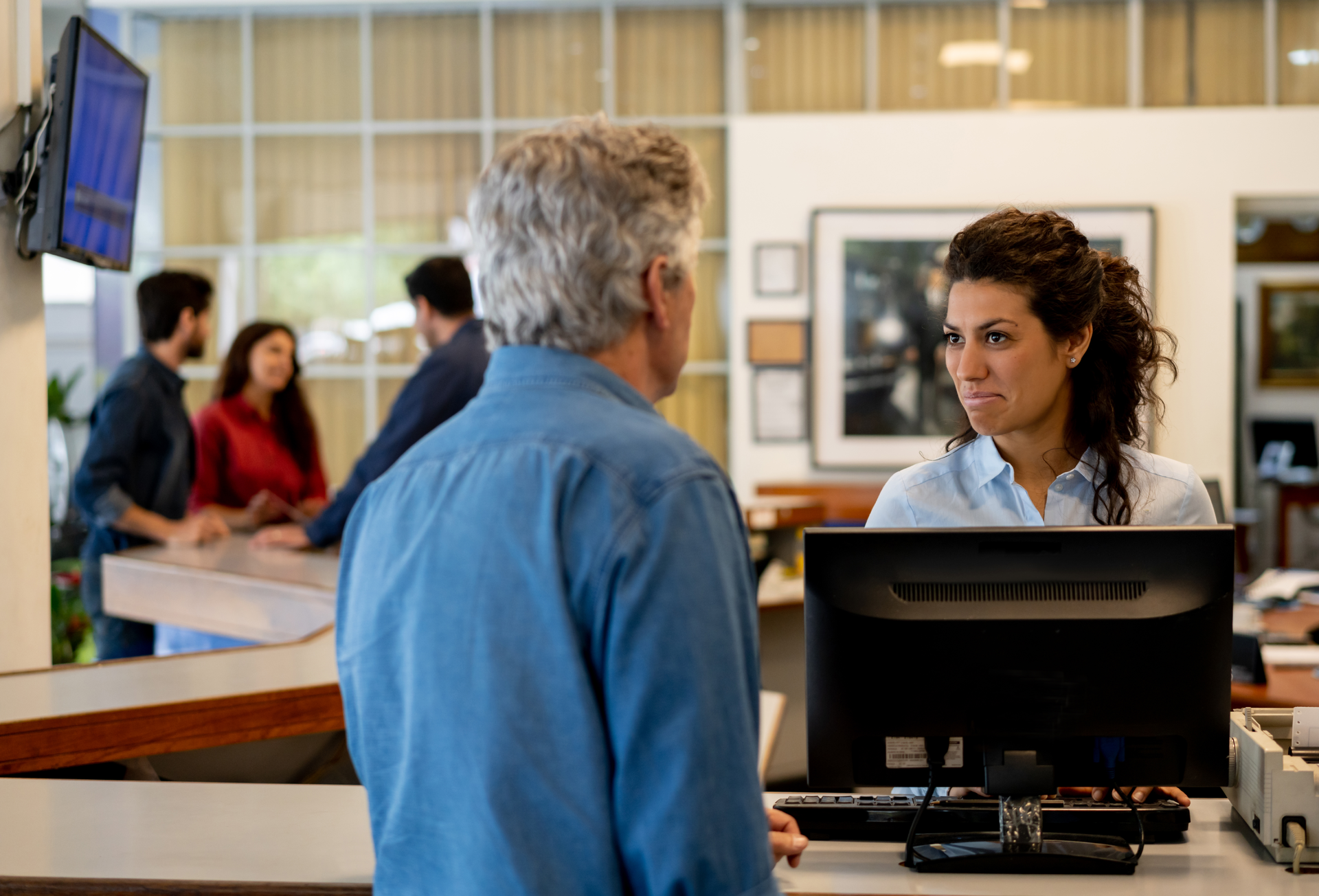 A service advisor speaks with a shop customer.
