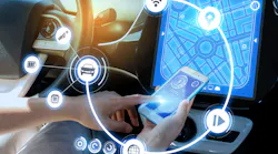 A driver connects their smartphone to their vehicle Bluetooth. Connected vehicle data has become the point of contention between OEMs and the automotive aftermarket.