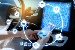 A driver connects their smartphone to their vehicle Bluetooth. Connected vehicle data has become the point of contention between OEMs and the automotive aftermarket.