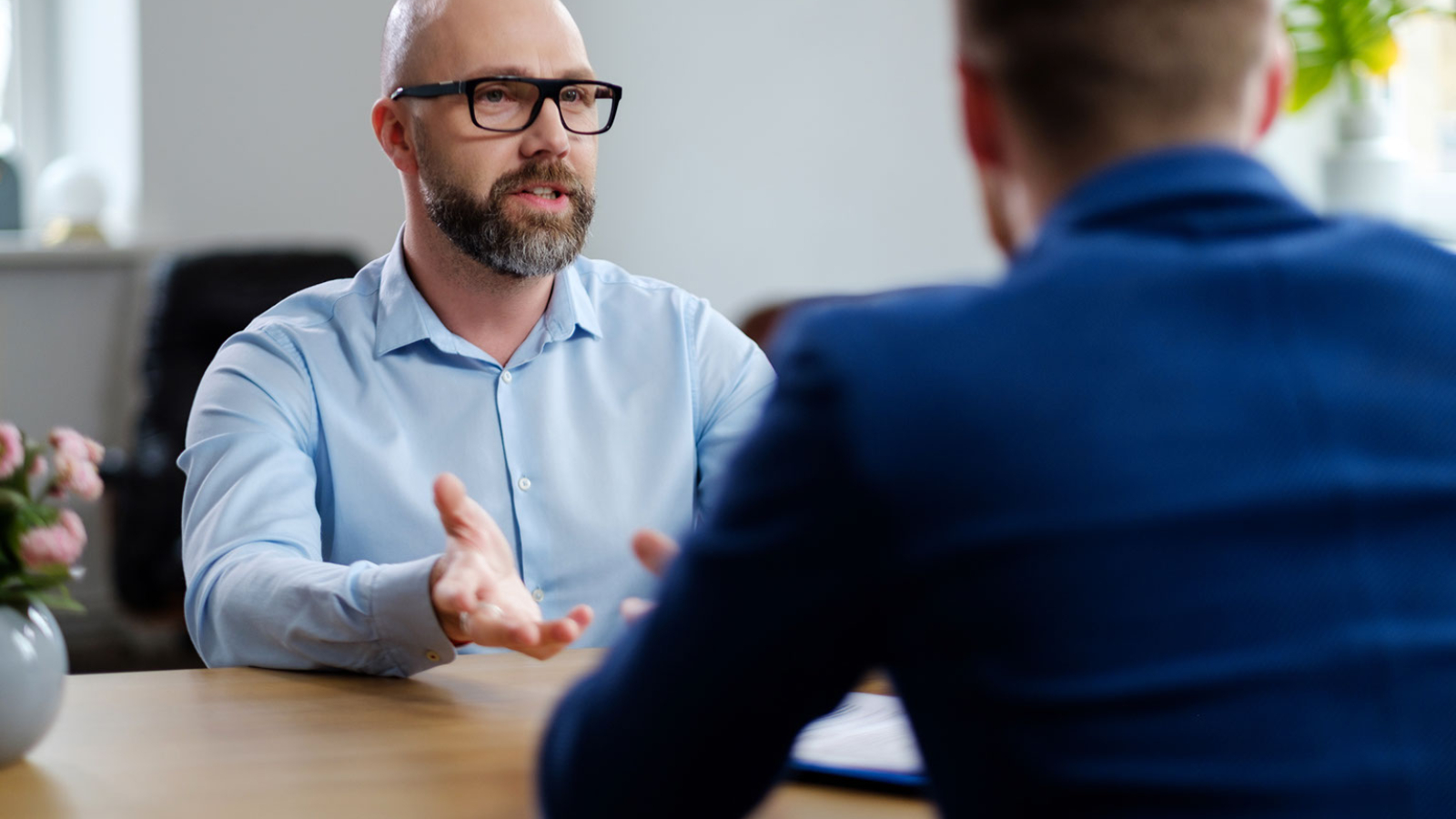 A business owner interviewing a candidate.