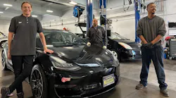 A decade of development: Earthling technicians Cara, Jeo, and Leon with a Tesla Model 3 and a Gen 2 Prius.