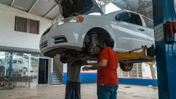 mechanics evaluate a vehicle on a lift